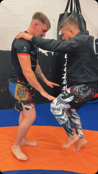 Wrestling clinch on our orange and blue mat