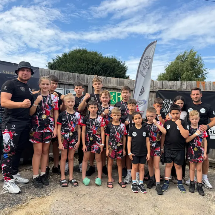 Our kids with medals and a championship belt