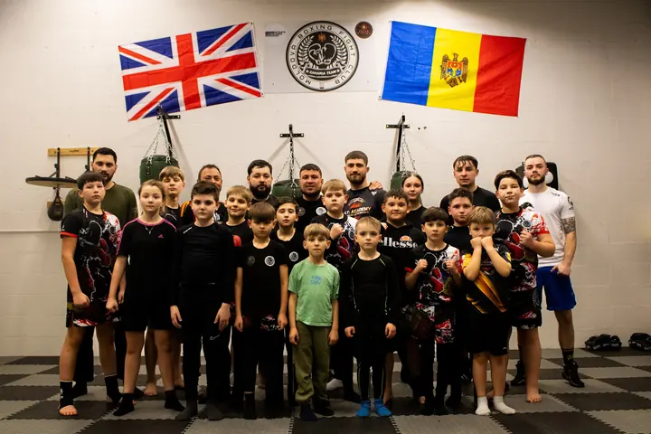 Our team in front of the UK and Moldovan flags